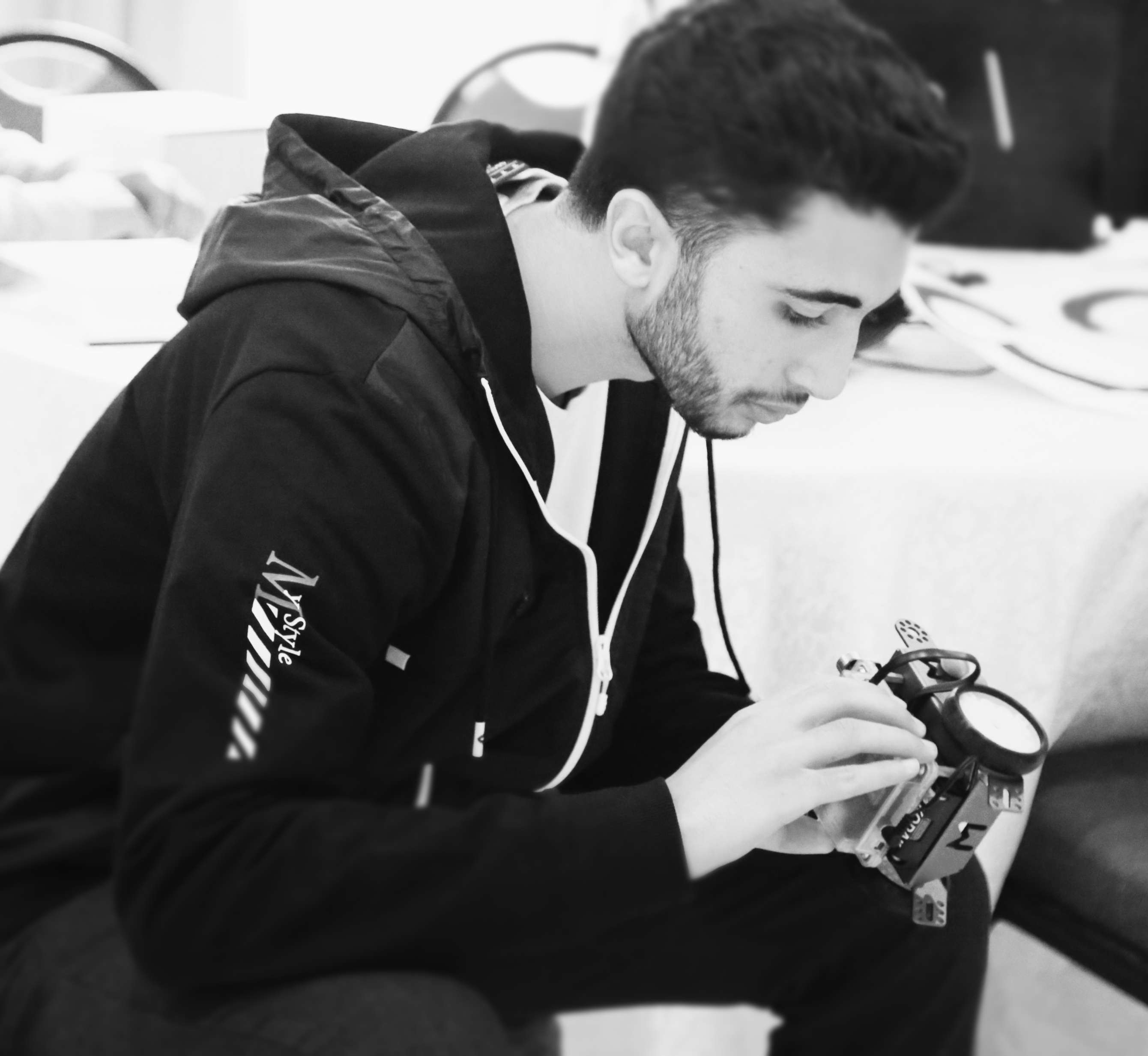 Abdallah Dridi examining hardware.